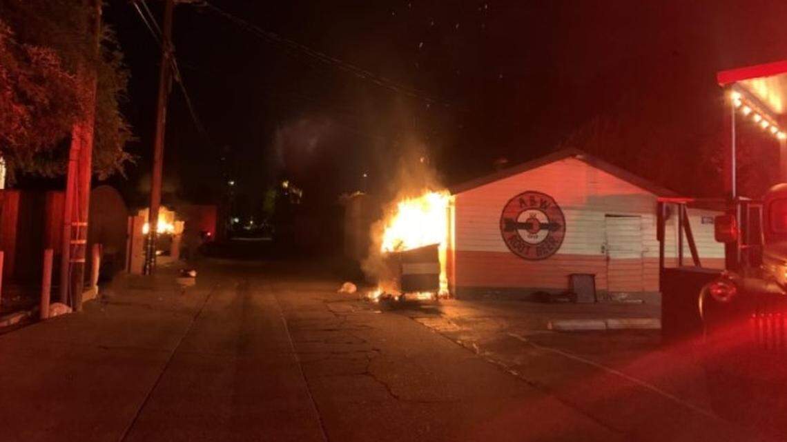 One of several dumpster fires early Monday, June 28, 2021, in downtown Modesto spread to the storage building of the A&W restaurant on G Street.