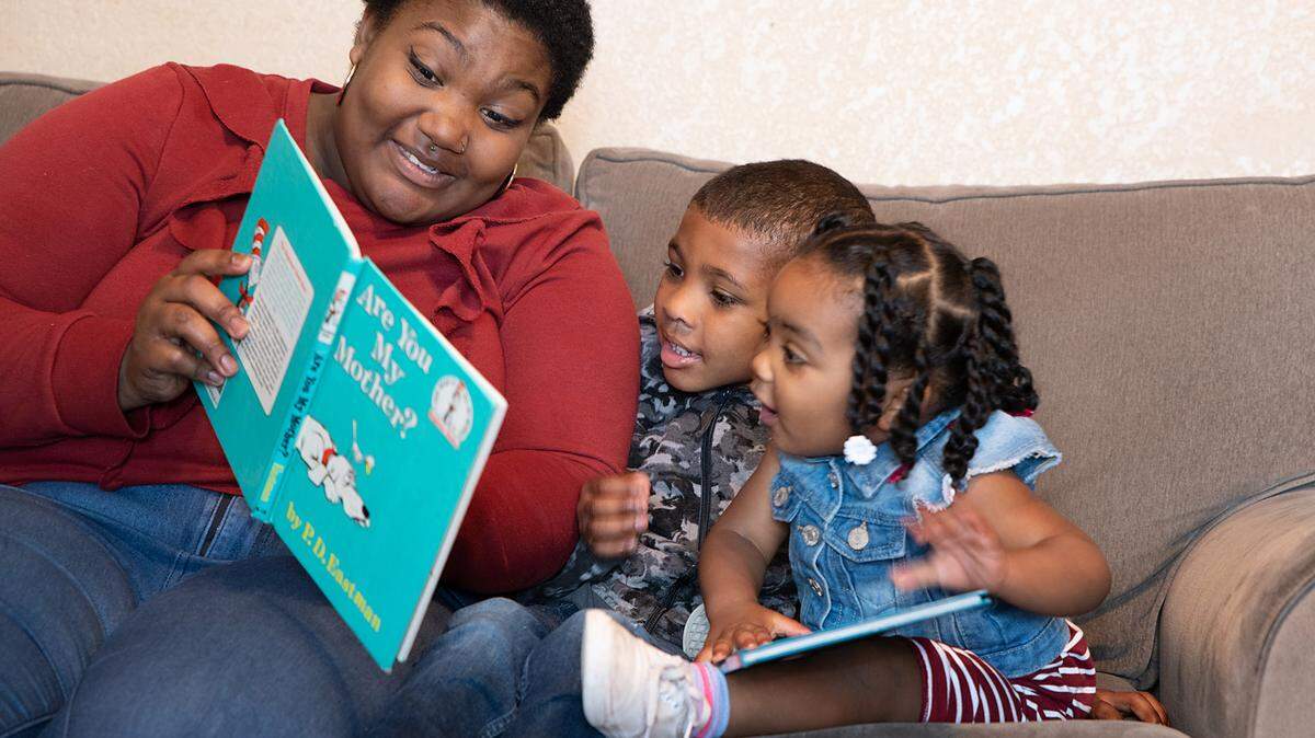 Lexus Julien reads to her children at the Redwood Family Center program in Modesto, including her son Kaidyn, 8, and daughter Arielle Marie, 1.