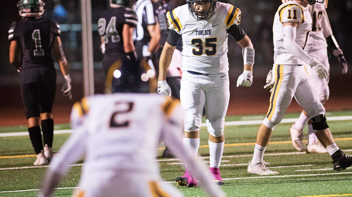 Turlock’s Cameran Sherwood (35) gestures to teammate Dalton Linn after scoring a 68-yard reception during the Central California Athletic League game with Pitman at Turlock High School in Turlock, Ca., on Friday, Oct. 26, 2018. 