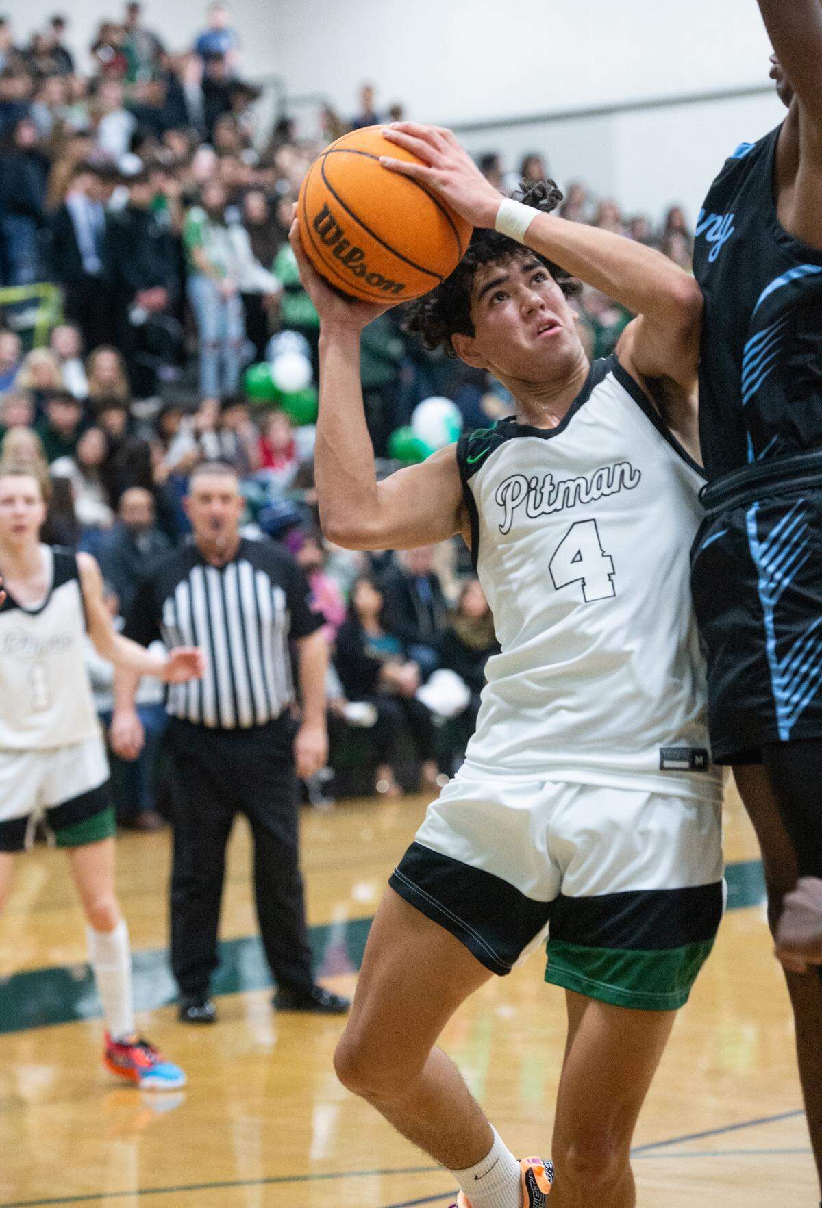 Pitman Justin Anderson is defended by Downey’s Reuben Lewis during the Central California Athletic League game in Turlock, Calif., Wednesday, Jan. 18, 2023. Downey won the game 52-44.
