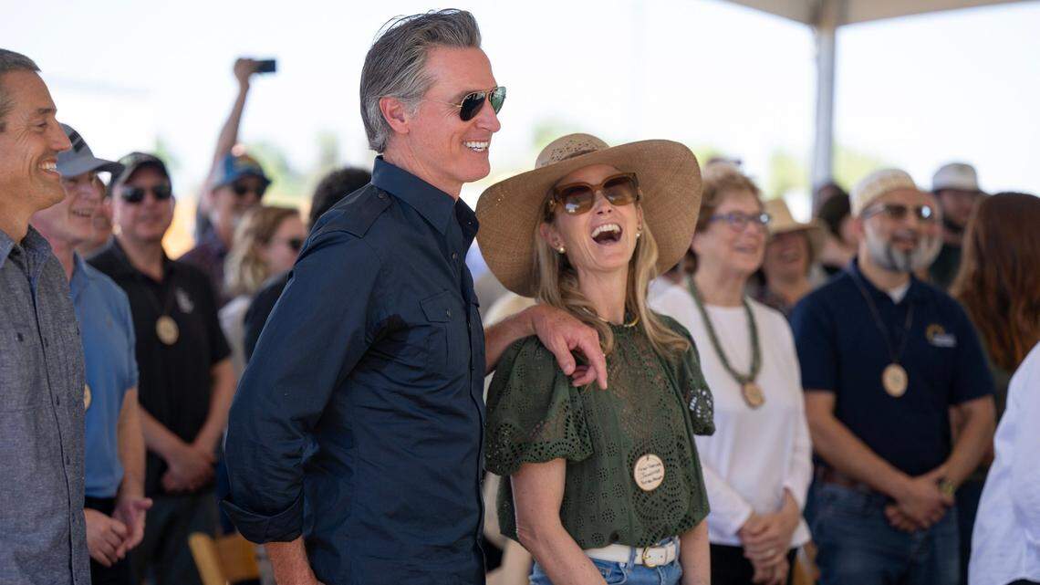Gov. Gavin Newsom and First Partner Jennifer Siebel Newsom laugh during a speech by Dolores Huerta during the dedication of the new Dos Rios State Park in the San Joaquin Valley in April.