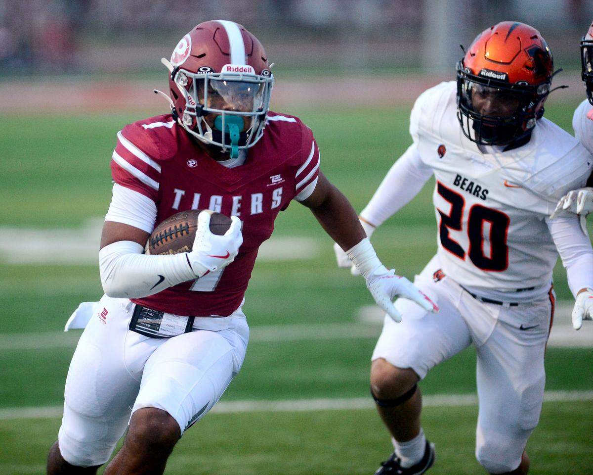 Patterson running back Jeremiah Lugo (1) races past a Merced defender during a game between Patterson High School and Merced High School at Patterson High on Aug. 23, 2024.