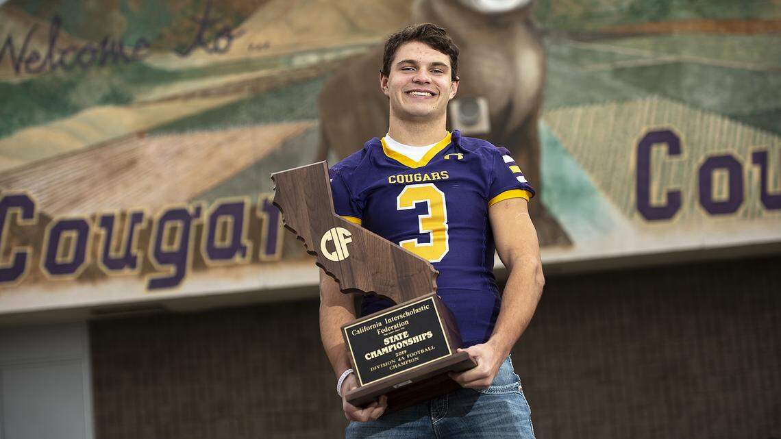 Bee player of the year Escalon’s Kaden Christensen hold the state title trophy at Escalon High School in Escalon, Calif., on Tuesday, Dec. 17, 2019.