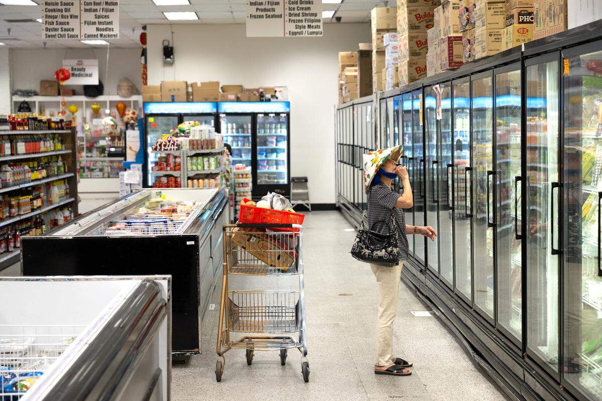 Asian Market co-owner Nai Truong looks over the cold case in Modesto, Wednesday, July 2, 2025.