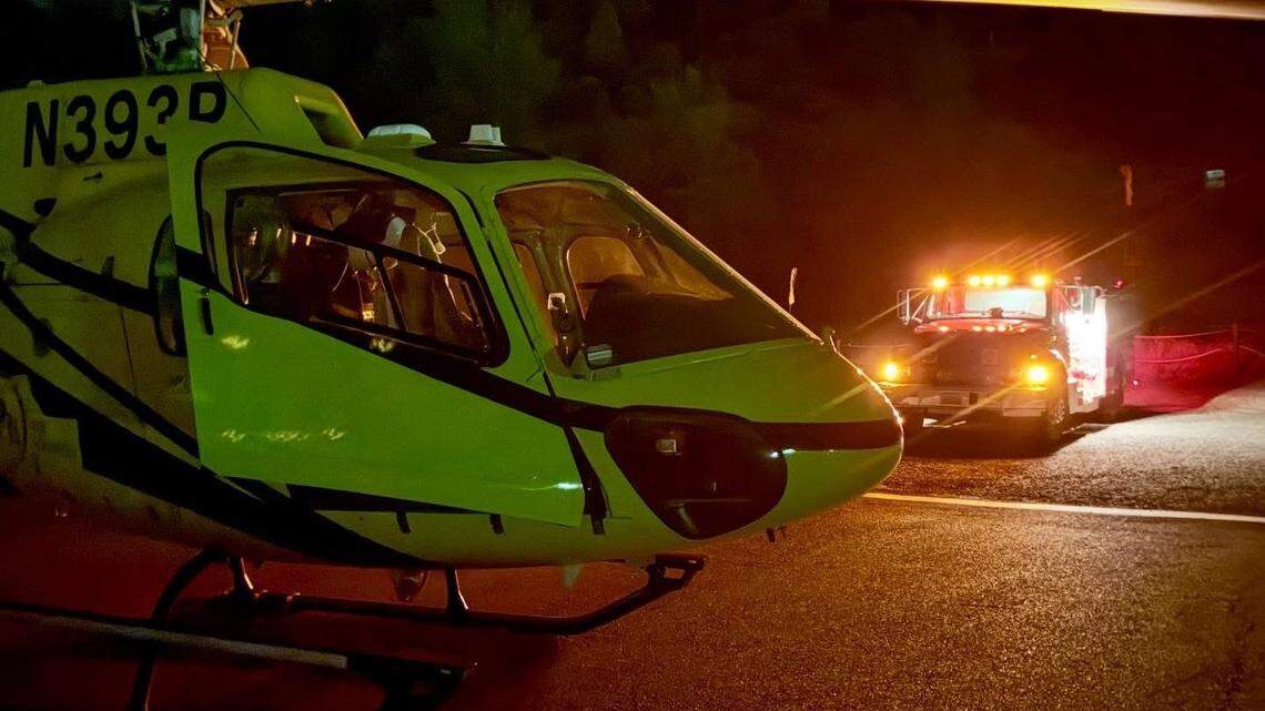 A medical helicopter lands near New Priest Grade on April 19, 2026, as emergency crews respond to a crash in which a vehicle went about 200 feet down an embankment. Two people were airlifted to trauma centers.