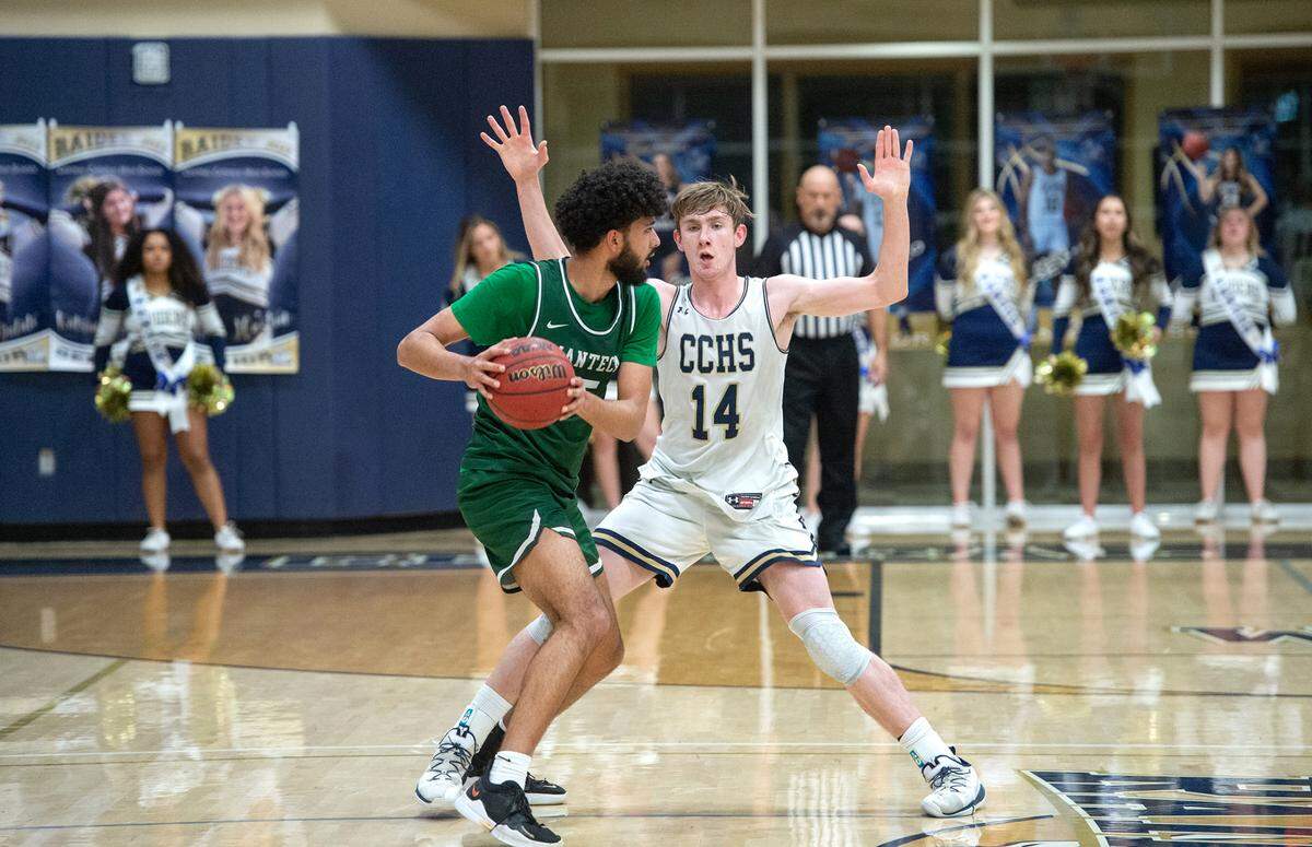 Central Catholic’s Wesley Payne defends on Manteca’s Mehtaj Mehrok during the Valley Oak League game at Central Catholic High School in Modesto, Calif., on Wednesday, Feb. 9, 2022. Manteca won the game 39-33.
