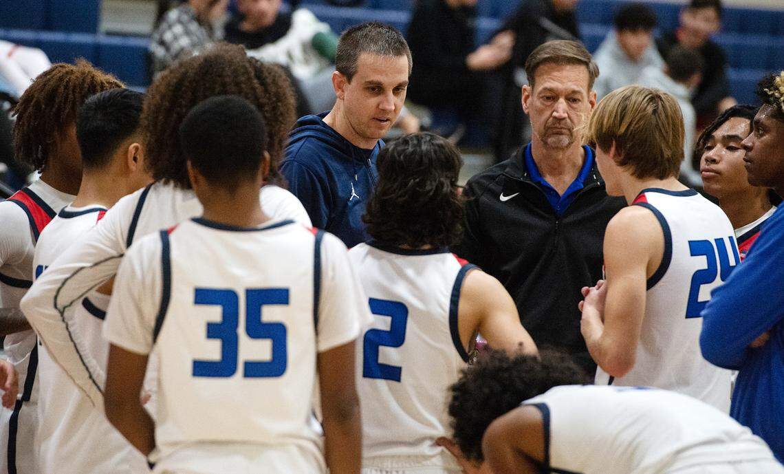 Beyer coach Kyle McKim, middle, talks with his players during the Western Athletic Conference game with Los Banos at Beyer High School in Modesto, Calif., Wednesday, Jan. 4, 2023.