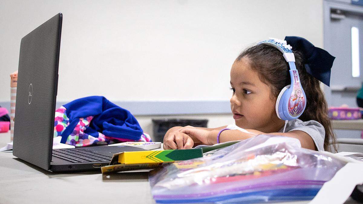 This Aug. 14, 2020 file image shows Xitlaly Andrade participating in class from the city of Turlock Distance Learning Camp in Turlock, Calif.. The city recreation department plans to open registration for its afterschool PLAY programs on July 29, 2021.