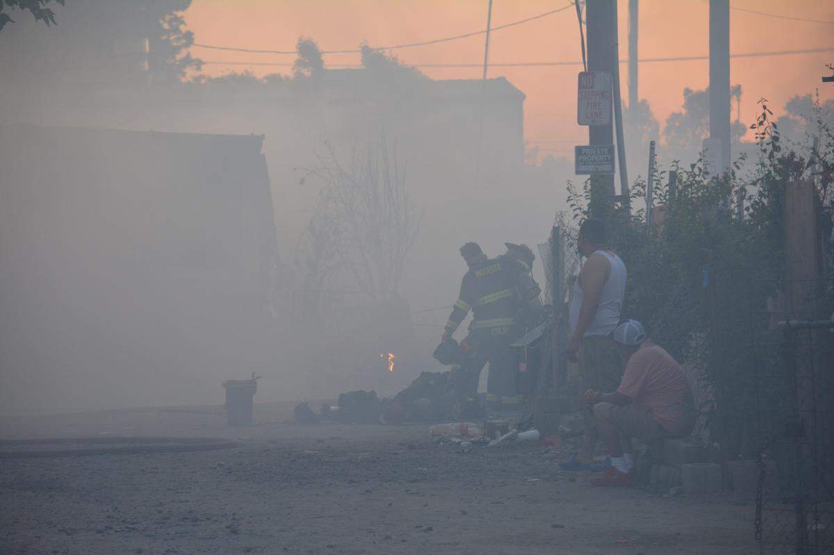 Smoke hung thick Wednesday night, May 25, 2022, at a mobile home park on South Seventh Street in Modesto where a three-alarm fire burned five homes, displacing 17 people.