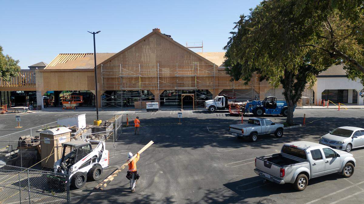 A crew works on the exterior of Wood Colony Plaza on Pelandale Avenue in Modesto, Calif., Tuesday Oct. 8, 2024.
