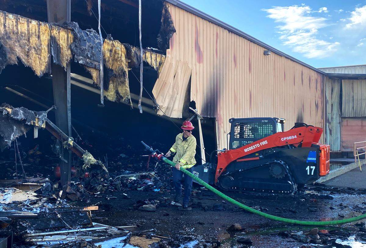 Modesto firefighters mop up from Thursday’s fire at The Salvation Army Family Thrift Store and Donation Center on north McHenry Avenue in Modesto. The fire was in the warehouse and its cause is under investigation.