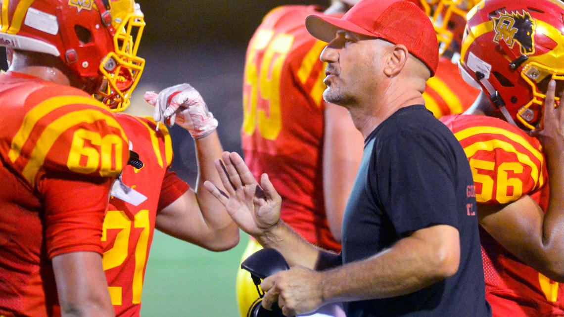 Oakdale head coach Trent Merzon talks to his players during a timeout in a game between Oakdale High School and Liberty High School at Oakdale High School in Oakdale California on August 30, 2019.