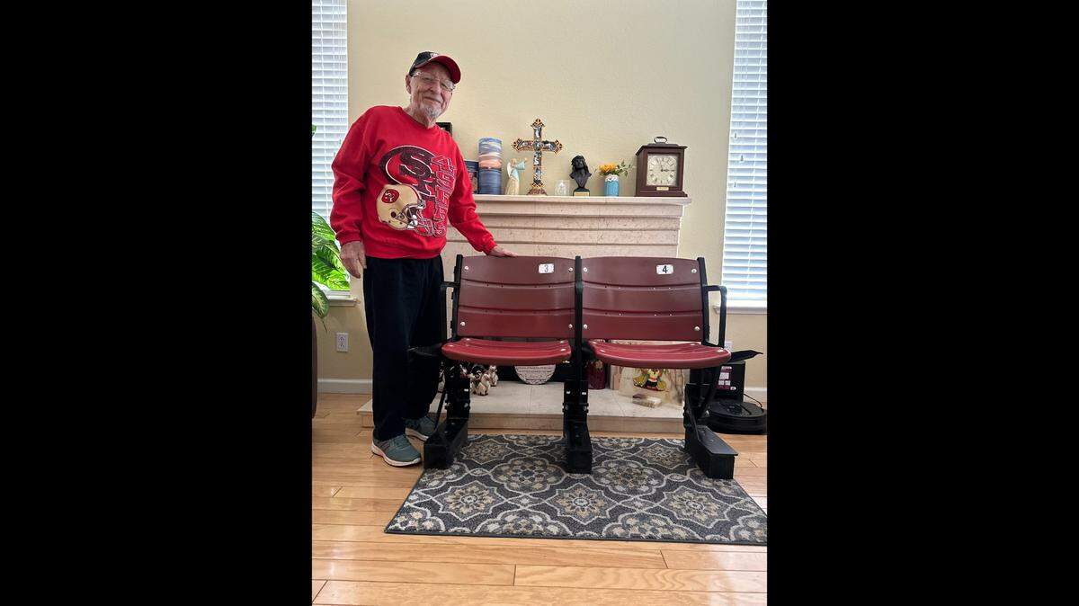 James Valdivia, de Modesto, aficionado de los Niners de casi 90 años, junto a los dos asientos del Candlestick Park que recibió como recuerdo tras el derribo del estadio.