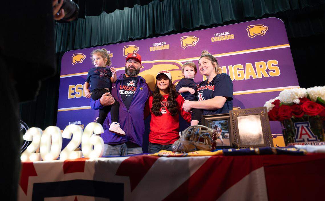 Escalon’s Madi Babasa, middle, seen here with her basketball coach Joe Dalpogetti and his family during a college signing ceremony in Escalon, Wednesday, Nov. 12, 2025. Babasa has signed to play softball at Arizona.