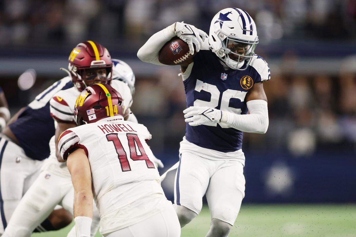 Dallas Cowboys cornerback DaRon Bland (26) returns an interception for a touchdown in the fourth quarter against Washington Commanders quarterback Sam Howell (14) at AT&T Stadium in Arlington, Texas, Nov 23, 2023.
