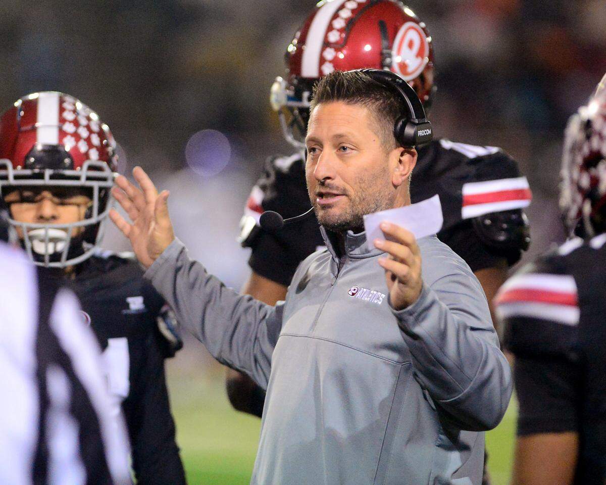 Patterson Head Coach Rob Cozart talks to his players during a Division IV Sac Joaquin Section Football Playoff game between Patterson and Kimball at Patterson High School in Patterson CA on November 10, 2023.