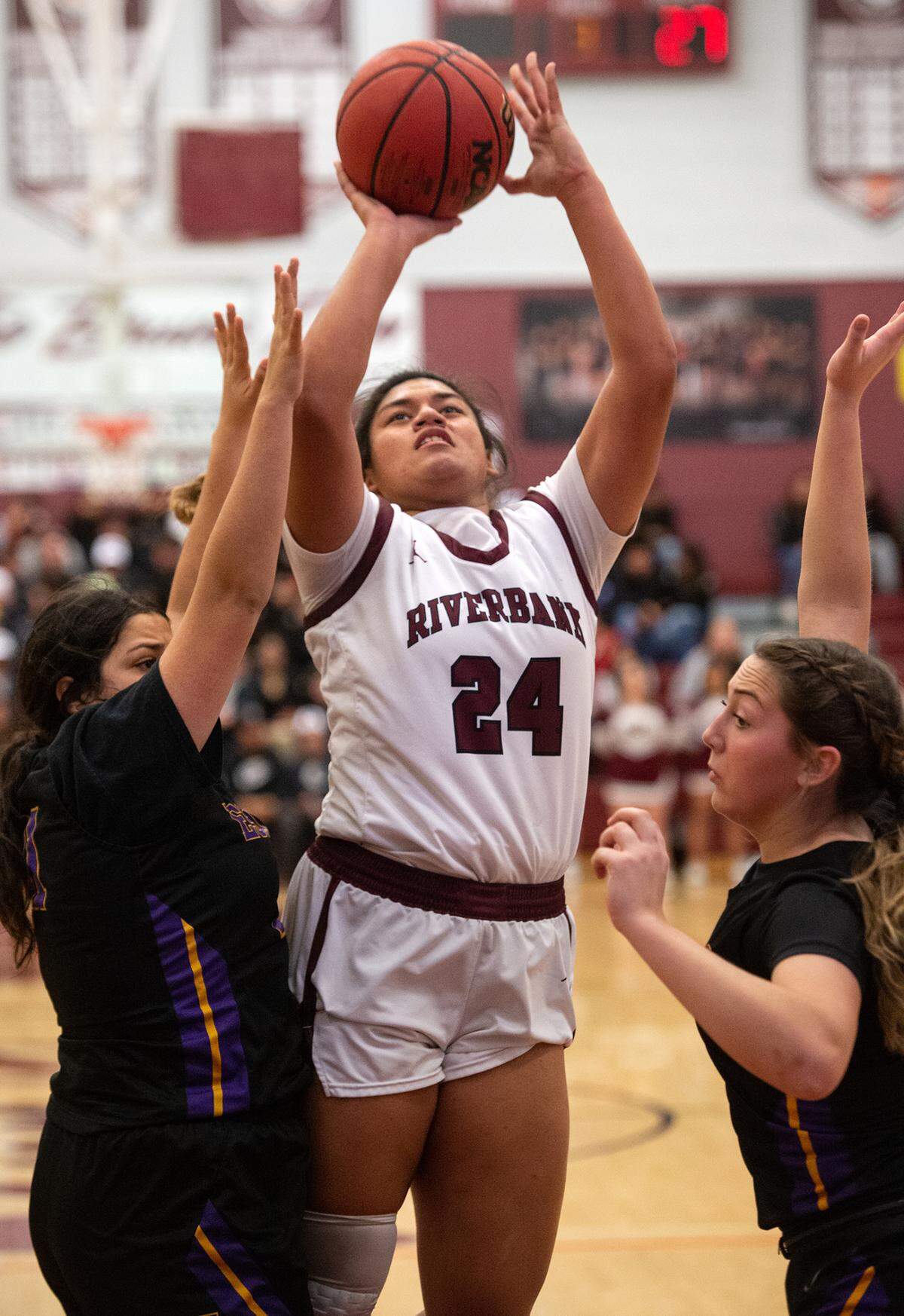 Riverbank’s Rayne Tago scores over Escalon defenders during the Sac-Joaquin section semifinal playoff game in Riverbank, Calif., Tuesday, Feb. 21, 2023.