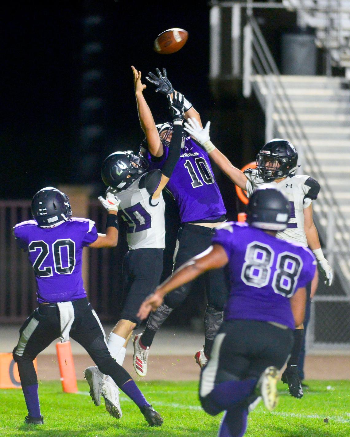 Johansen receiver Tiernan Collins (10) goes up for a ball over two Pacheco defenders during a game between Johansen High School and Pacheco High School at Johansen High School in Modesto California on September 20, 2019.