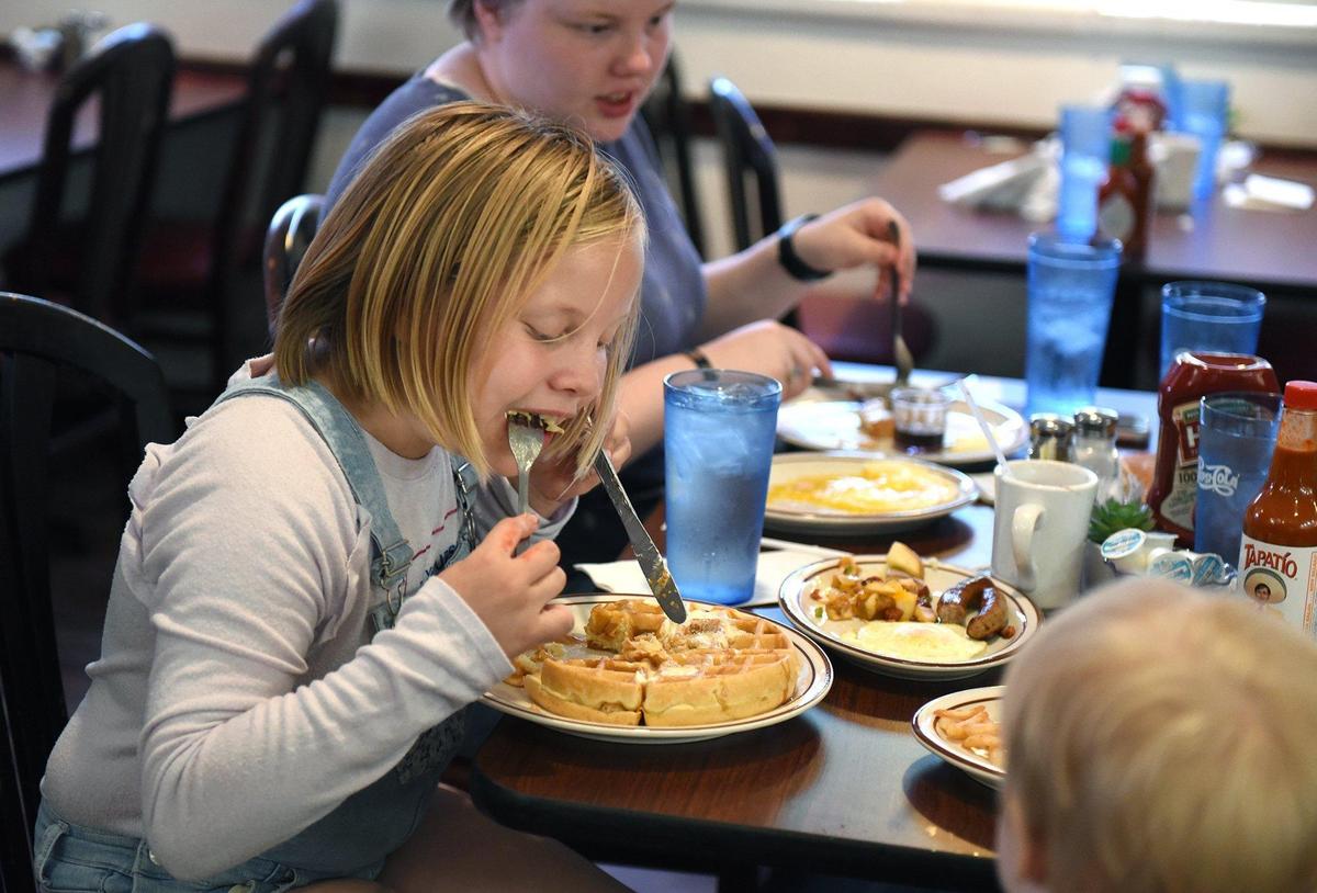 Della Newton 9yrs enjoys her waffle at My Garden Cafe in Turlock, Calif. on Saturday morning May 25, 2019.