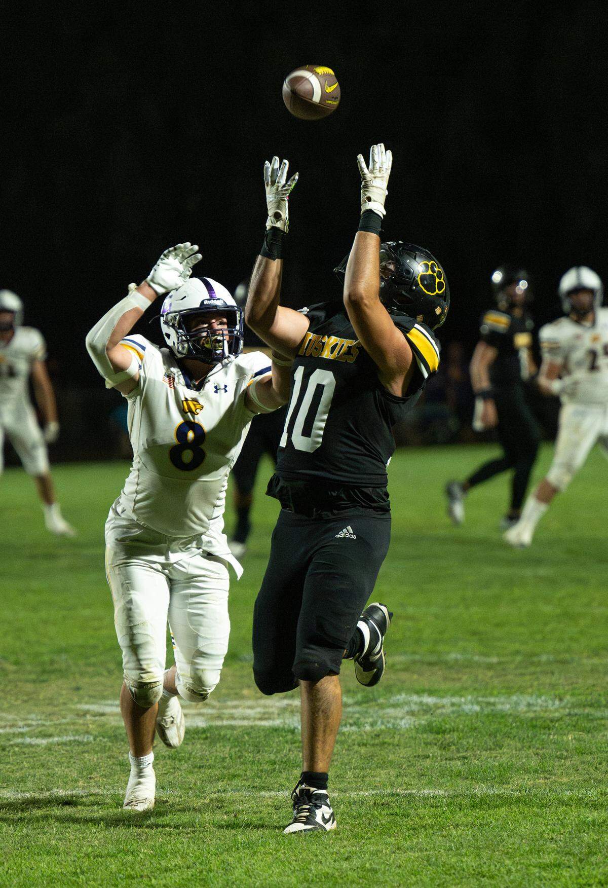 Hughson’s Max Mankins makes a catch past Escalon defender Carson Medina during the Trans Valley League game in Hughson, Calif., Friday, Oct. 4, 2024.