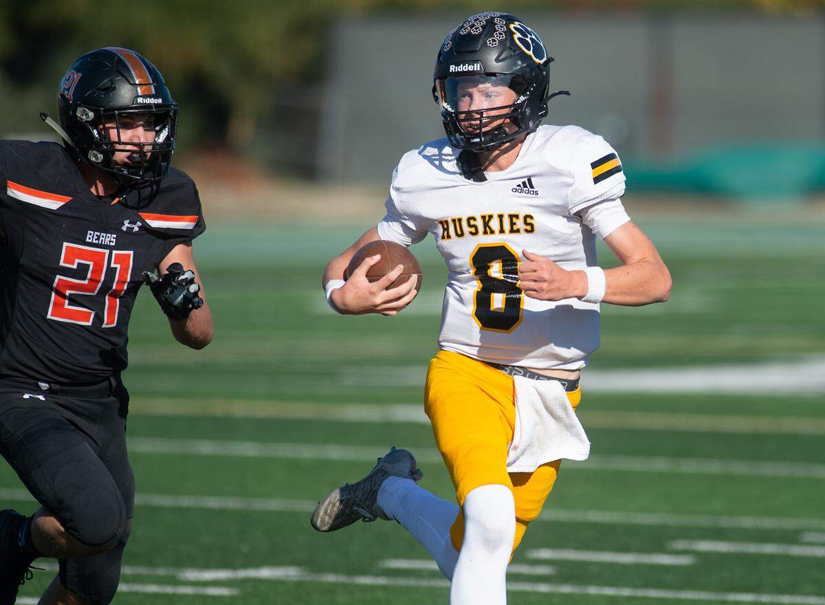 Hughson quarterback Robert McDaniel is pursed by Summerville’s Logan Slater during the Sac-Joaquin Section Division VI championship game at St. Mary’s High School in Stockton, Calif., Saturday, Nov. 26, 2022.