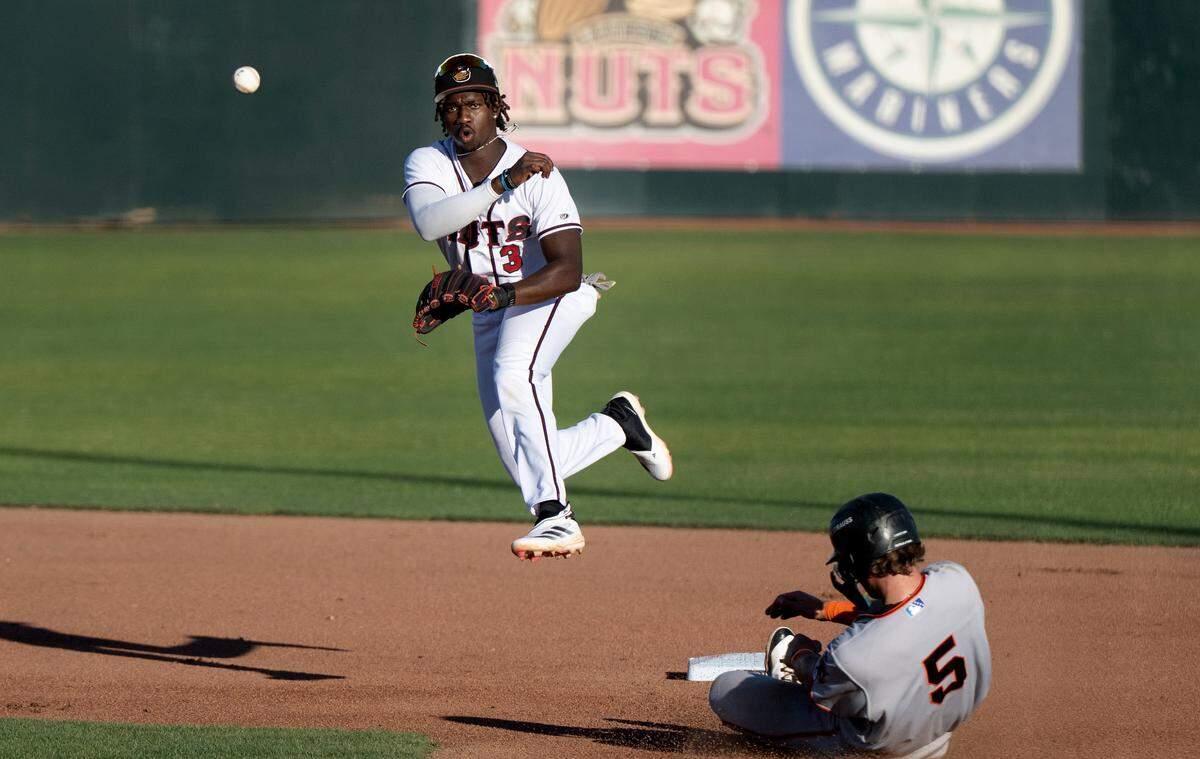 Modesto Nuts shortstop Felnin Celesten turns a double play during the game with the San Jose Giants at John Thurman Field in Modesto, Wednesday, June 18, 2025. The Giants clinched the California League North Division first half championship with a 5-2 victory.