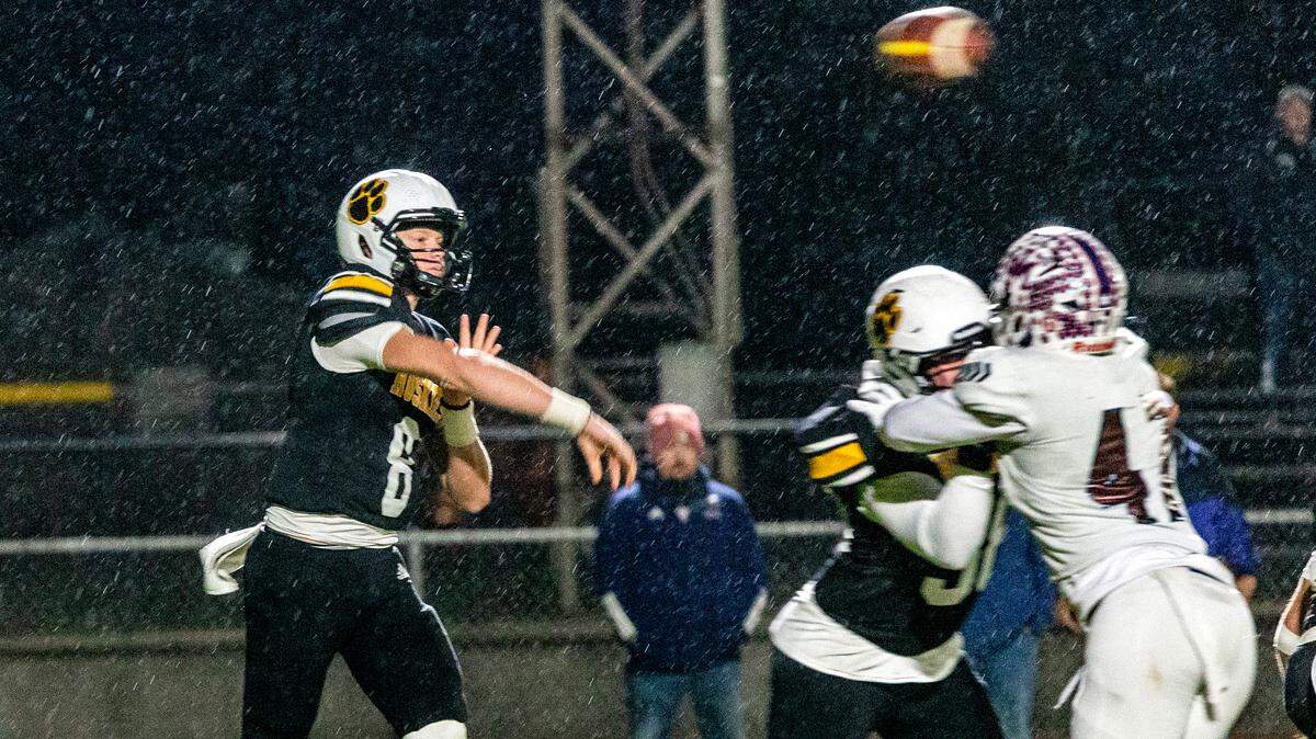 Quarterback, Robert McDaniel, 8, of Hughson High throws a pass upfield as Union Mine closes in Friday, Nov. 22, 2024 for the CIF SJS Semifinals football Championships at Hughson High. .
