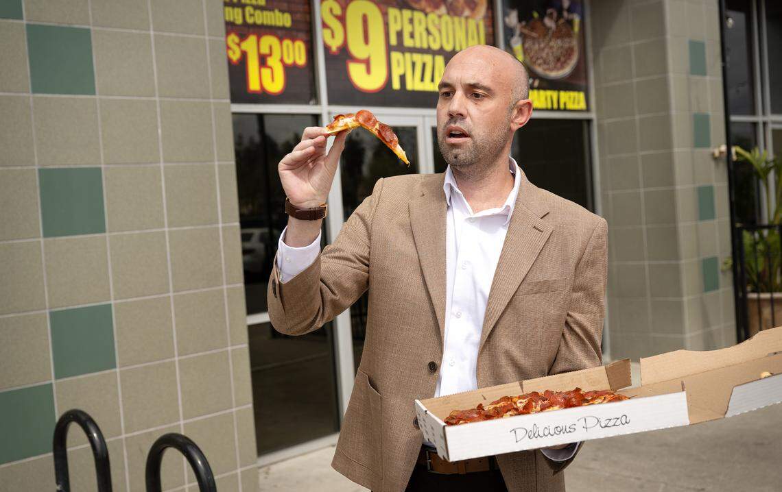 Reviewer Damien Wilson observes the “flop” of a slice of pepperoni pizza at Rico’s Pizza in Turlock, Thursday, March 27, 2025.