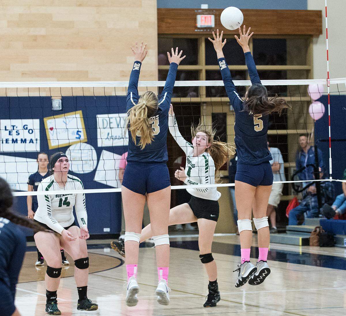 Manteca’s Karlie Spohn floats the ball past Central Catholic defenders Grace Mathias (33) and Lauren Gary (5) during the Valley Oak League match at Central Catholic High School in Modesto, Calif., on Thursday, Oct. 4, 2018.