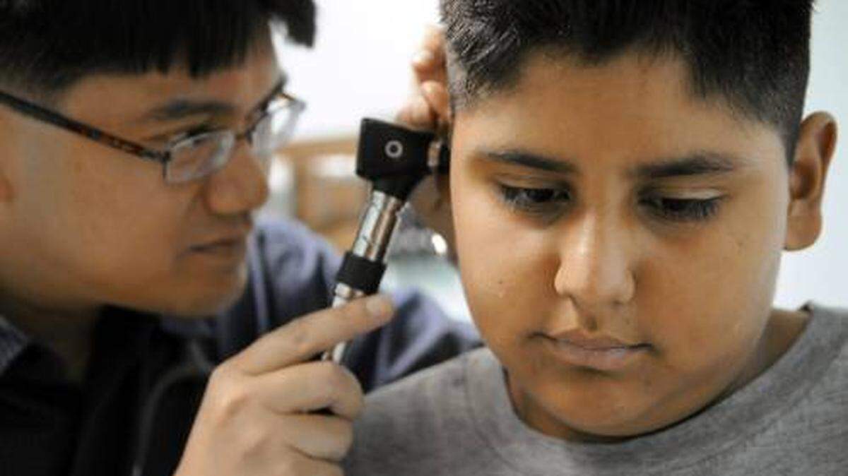 Andres Castillo Jr. gets a check up from Dr. Jonas Bernal through the Healthy Families program at Stanislaus County Health Services in Modesto, Calif.,  Wednesday, July 22, 2009. How will the state budget impact Healthy Families, the low-cost insurance pr
