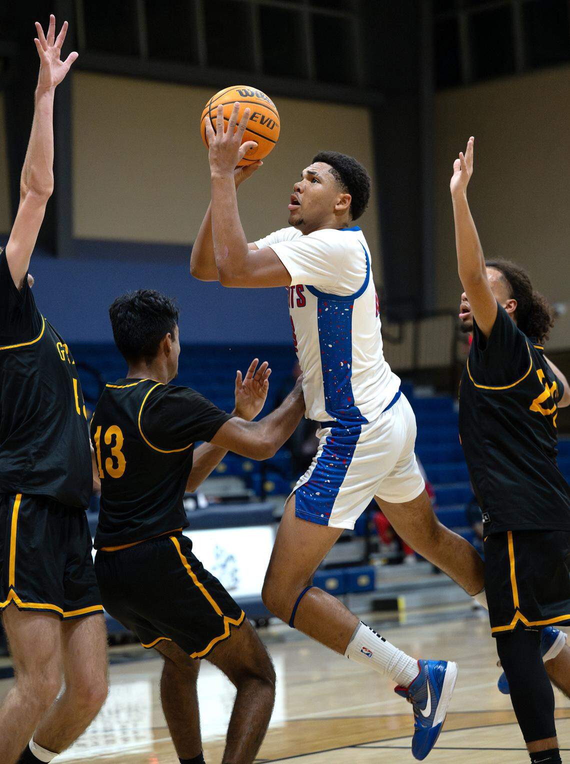 Beyer’s Curtis Harmon makes a basket surrounded by Gregori defenders during the Mark Gallo Invitational basketball tournament game at Central Catholic High School in Modesto, Friday, Dec. 13, 2024.