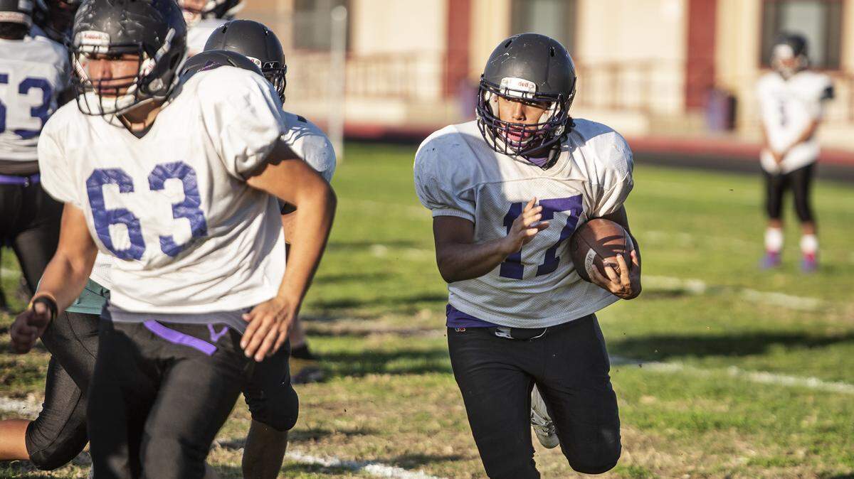 Johansen senior Jesse Arriola runs the ball during practice at Johansen High School in Modesto, Calif., Tuesday, Oct. 22, 2019.