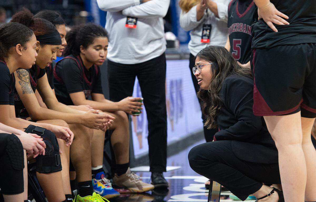 Riverbank coach Janelle Luu talks with her players on a timeout during the Sac-Joaquin Section Division IV championship game with Colfax at Golden 1 Center in Sacramento, Calif., Friday, Feb. 24, 2023.
