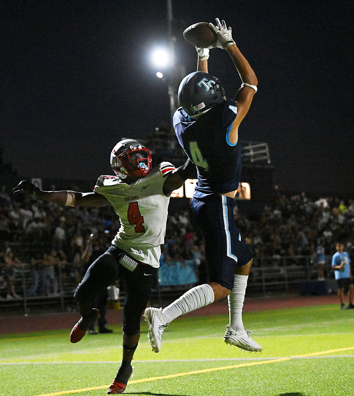Downey’s Joseph Ramirez reaches up for a touchdown catch as Lincoln’s Daniel Emojevbe defends during the non-league game at Downey High School in Modesto, Calif., Friday, August 18, 2023.
