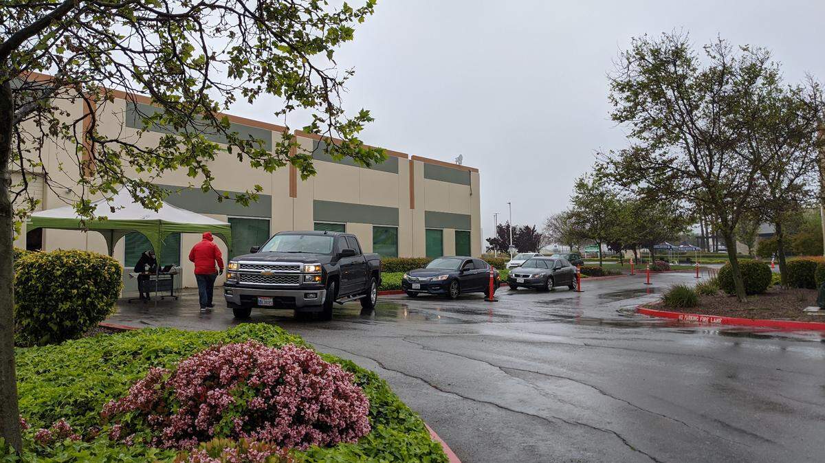 The families of Patterson students pick up Chromebooks in April after schools in Stanislaus County closed campuses and switched to distance learning.