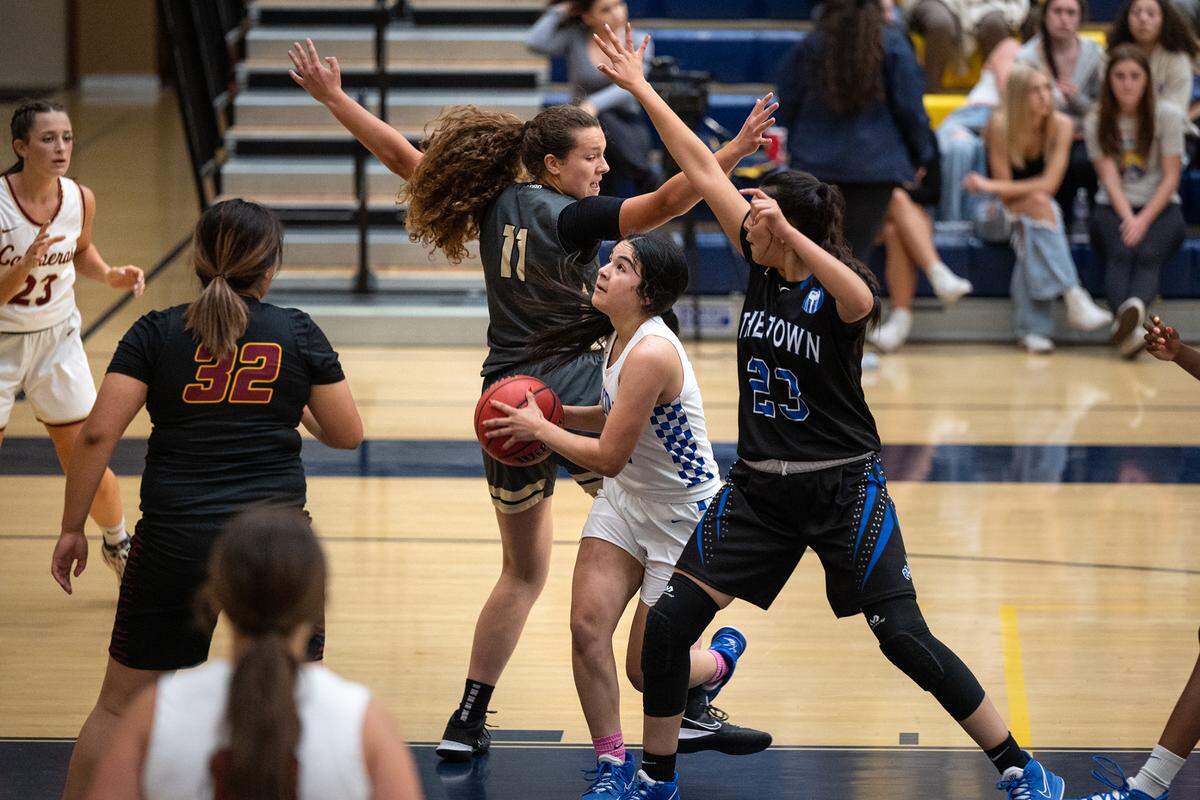 Atwater’s Aliene Lopez, middle, drives to the basket past Buhach Colony’s Skyler Dietz (11) and Atwater’s Maya Manzanares (23) during the Six-County Senior All-Star Basketball Game at Gregori High School in Salida, Friday, May 6, 2022.