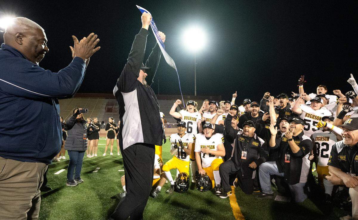 Head coach Shaun King holds the section banner as Hughson celebrates their 40-39 victory over Bradshaw Christian in the Sac-Joaquin Section Division VI championship game at Sacramento City College in Sacramento, Calif., Saturday, Nov. 25, 2023.