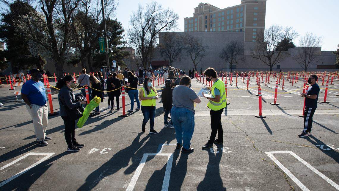 Educators and teachers line up outside the east entrance of Modesto Centre Plaza for COVID-19 vaccinations in Modesto, Calif., on Thursday, March 4, 2021.