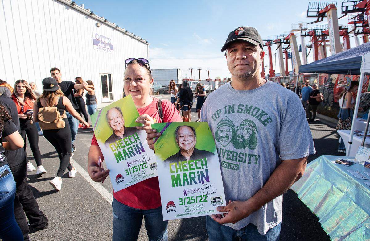 Joseph Lopes and Krystal Lemere hold autographed posters of Cheech Marin. Marin of Cheech & Chong fame came to Jayden’s Journey cannabis dispensary for Epilepsy Awareness Day in Modesto, Calif., on Friday, March 25, 2022.