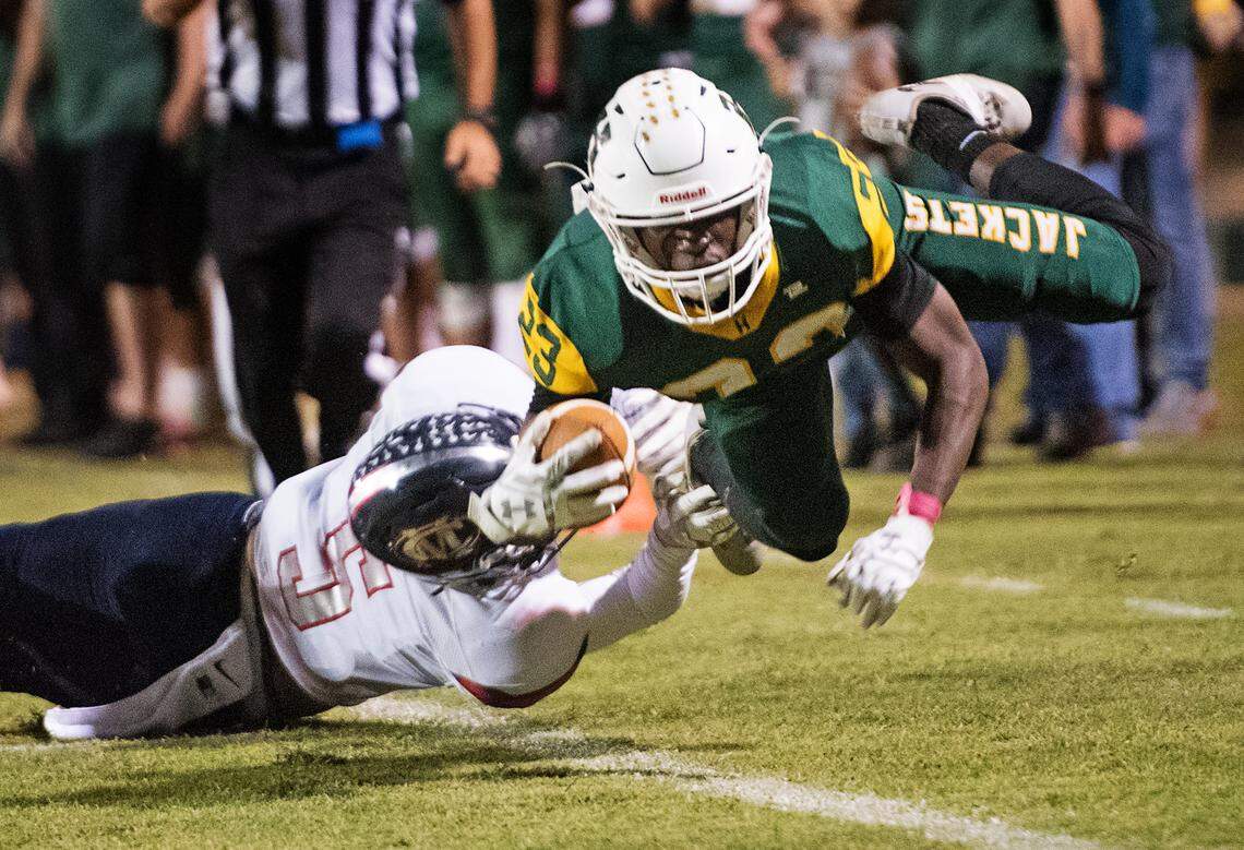 Hilmar’s Issac Sharp is knocked out of bounds by Modesto Christian’s Mario Hernandez during the Trans Valley League game at Hilmar High School in Hilmar, Calif., on Friday, Oct. 12, 2018. Modesto Christian won the game 24-21.