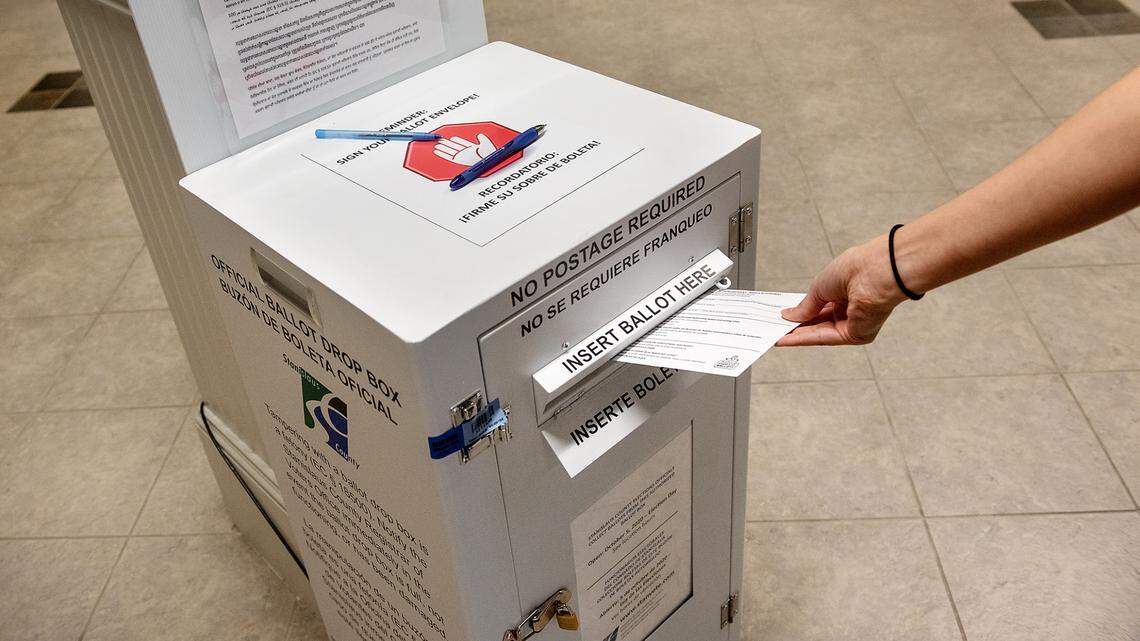 A voter drops thier ballot at Turlock City Hall in Turlock, Calif., on Thursday Oct. 29, 2020.