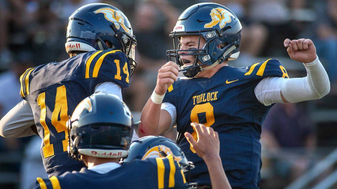 Logan Hart celebrates with quarterback Cole Gilbert after a big reception during the non-league game with Clayton Valley Charter at Turlock High School in Turlock, Calif., on Monday, Aug. 30, 2021. The catch set up a third quarter touchdown.