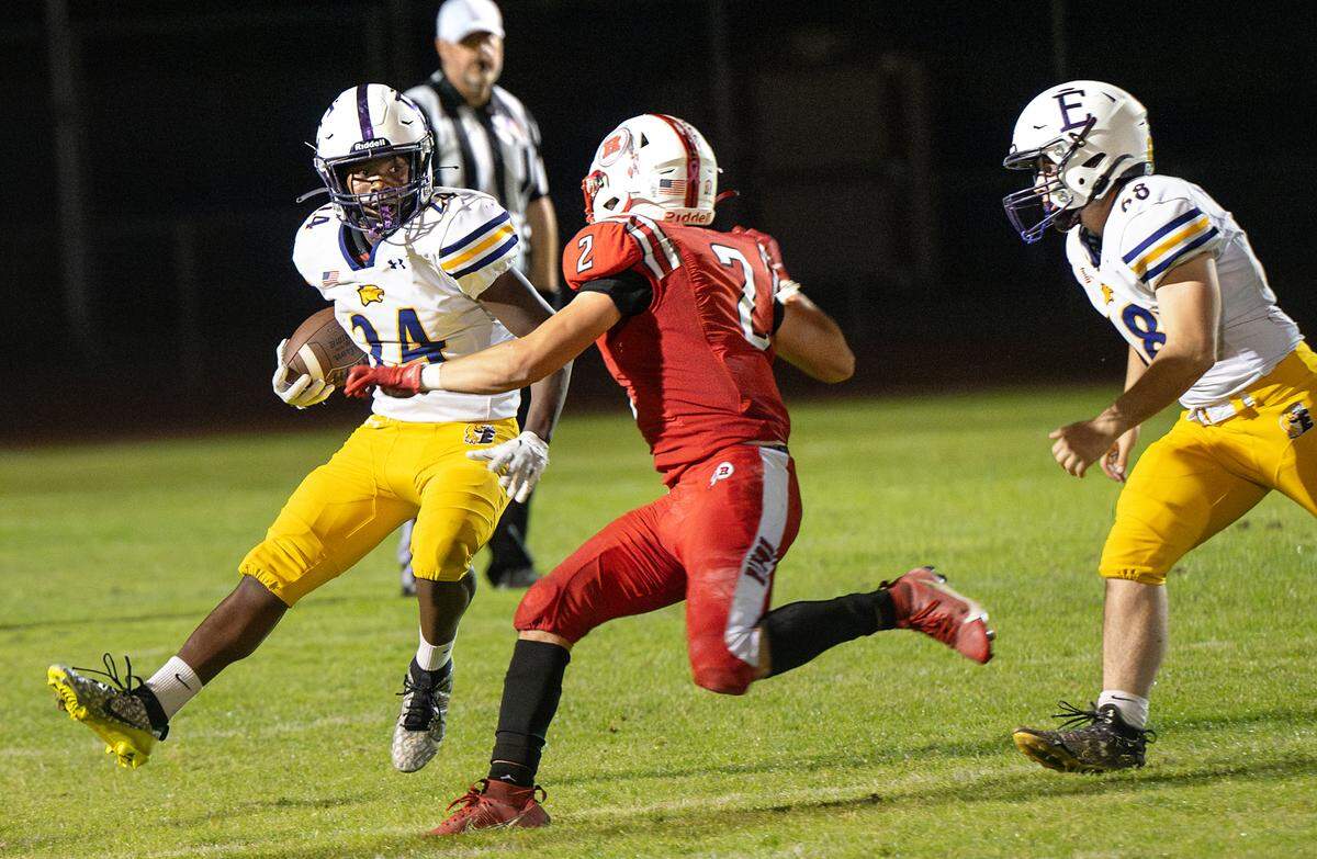 Escalon’s Kamari Castro runs the ball up to Ripon defender Logan Lefebvre during the Trans-Valley League game at Ripon High School in Ripon, Friday, Oct. 25, 2024. Escalon won the game 23-14.