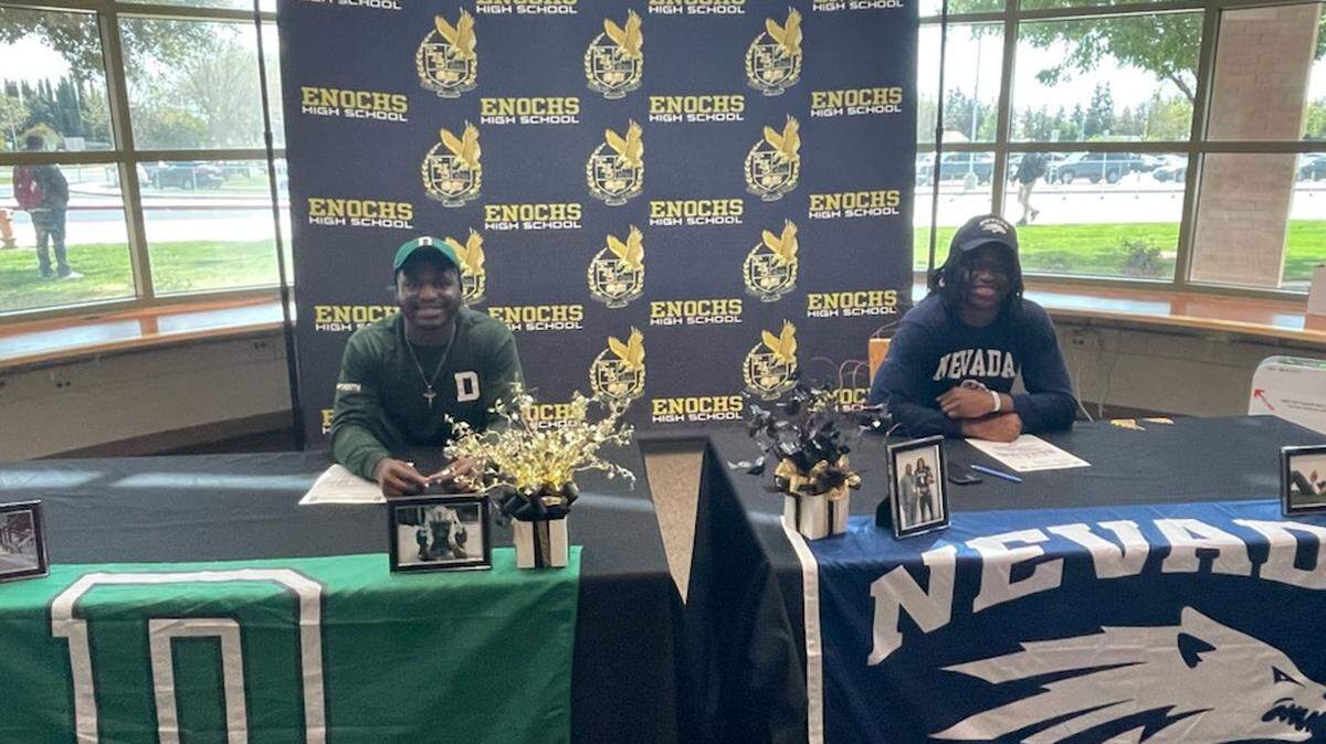 Twins Yomi (left) and Kola (right) signed letters of intent to play NCAA Division I football at Enochs High School on Thursday, March 31, 2022