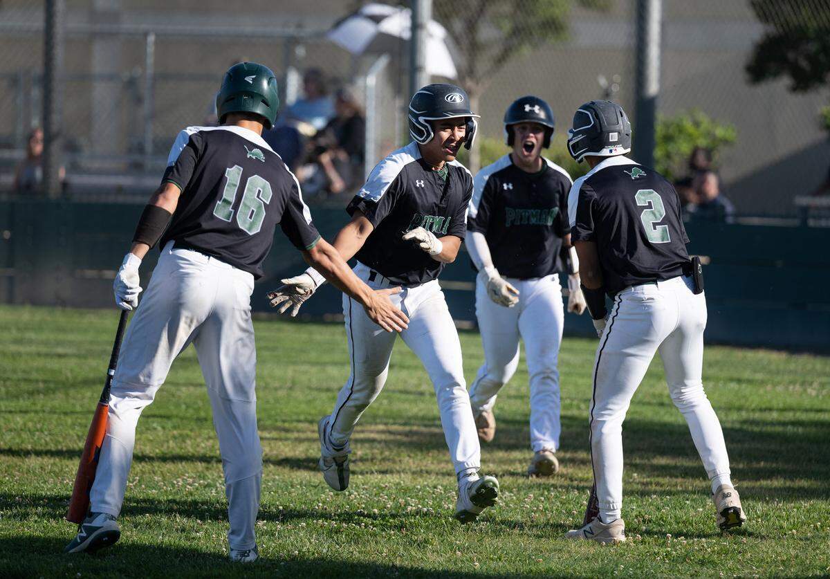 Pitman players celebrate a base clearing fly ball during Sac-Joaquin Section Division 2 baseball playoff game with Rodriguez at Pitman High School in Turlock, Calif., Thursday, May 11, 2023.