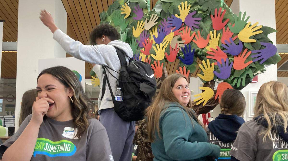 Pitman High School student Stefany Perez, left, and Turlock High School student Berry Ward finish placing their handprints on a tree during an activity at the March 9 Cal-STOP SAVE Promise Club Youth Leadership Training Workshop. Student leaders wrote positive traits or “super powers” on the colorful cutouts to represent what they bring to the Turlock Unified School District community.