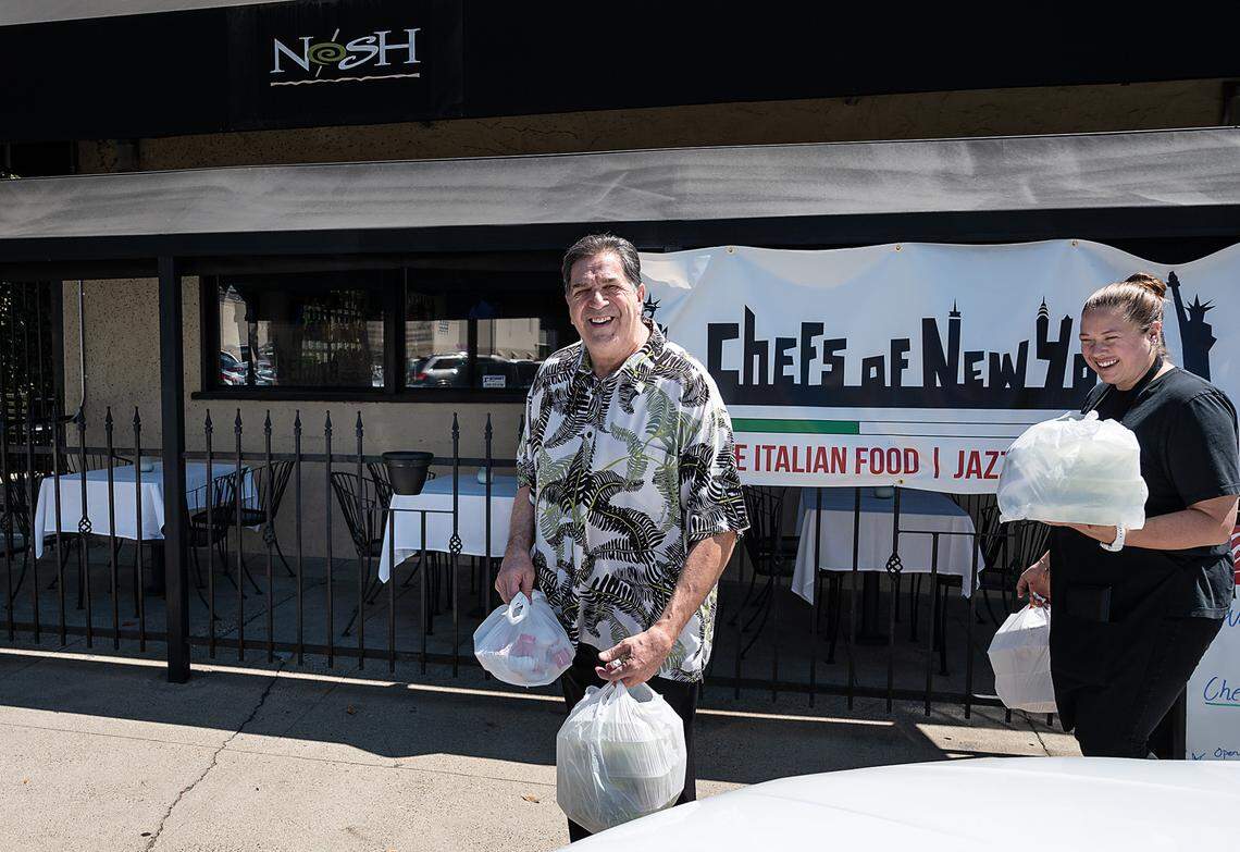 Vinny Altadonna, left, and Kimberly Altadonna head out to deliver some lunch orders at Chefs of New York Italian restaurant in Modesto, Calif., on Friday, July 9, 2021.