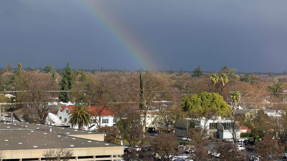 A rainbow is pictured through the clouds on Monday afternoon February 4, 2019 looking east from 10th and H streets in Modesto, Calif.