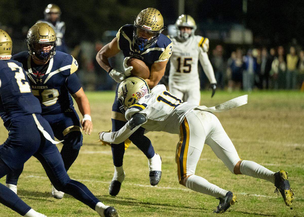 Turlock’s Landyn Fitzgerald stops Central Catholic runner Joseph Stewart during the Sac-Joaquin Section Division I playoff game at Central Catholic High School in Modesto, Friday, Nov. 15, 2024.