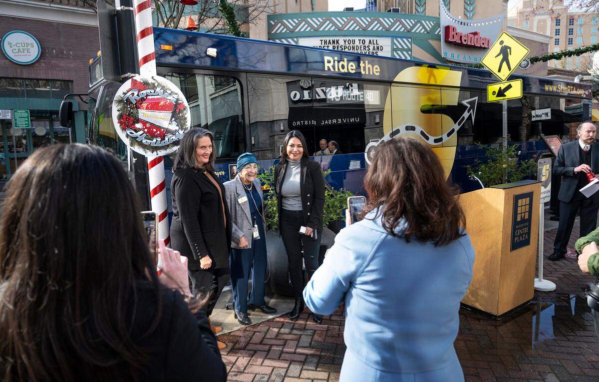 Jenny Kenoyer poses for pictures with Modesto mayor Sue Zwahlen and council member Rosa Escutia-Braaton after the SRTA revealed the first repainted in honor of Kenoyer. The newly branded Stanislaus Regional Transit Authority bus was officially unveiled in Modesto, Calif., on Thursday, Dec. 16, 2021. The Modesto Area Express, better known as MAX, and Stanislaus Regional Transit, or START have merged into one provider, Stanislaus Regional Transit Authority.